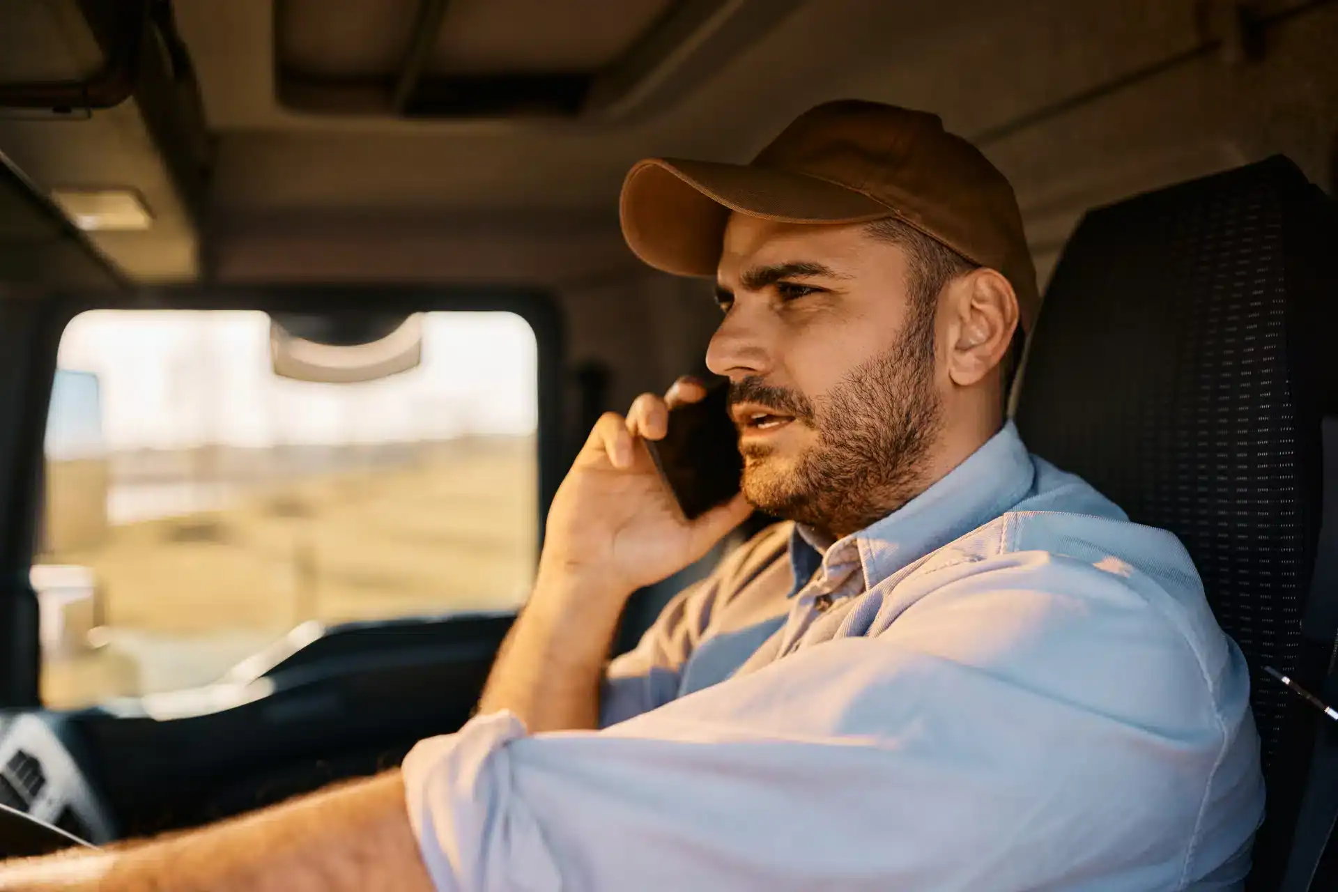 truck-driver-talking-on-cell-phone-while-driving-2024-12-13-22-19-05-utc
